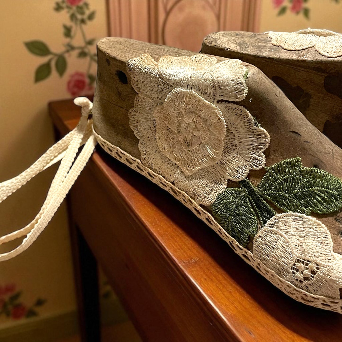 Antiche forme per scarpe con pizzi e passamaneria panna e verde