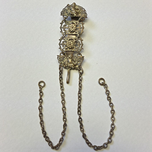 Chatelaine reggi calze con putti, lega metallica, fine ‘800 - primo ‘900