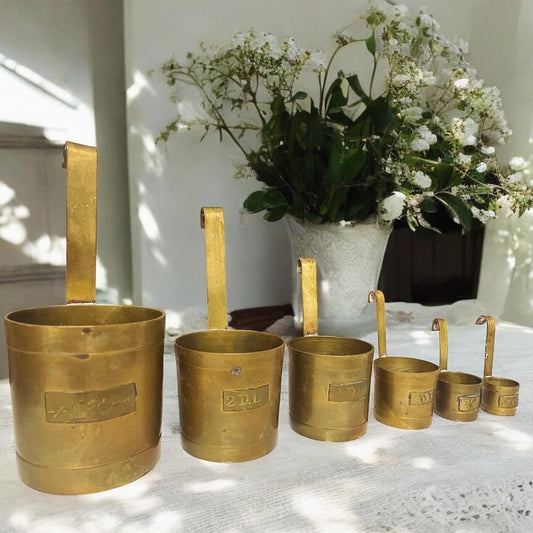 Set of antique Dutch workshop brass measuring cups