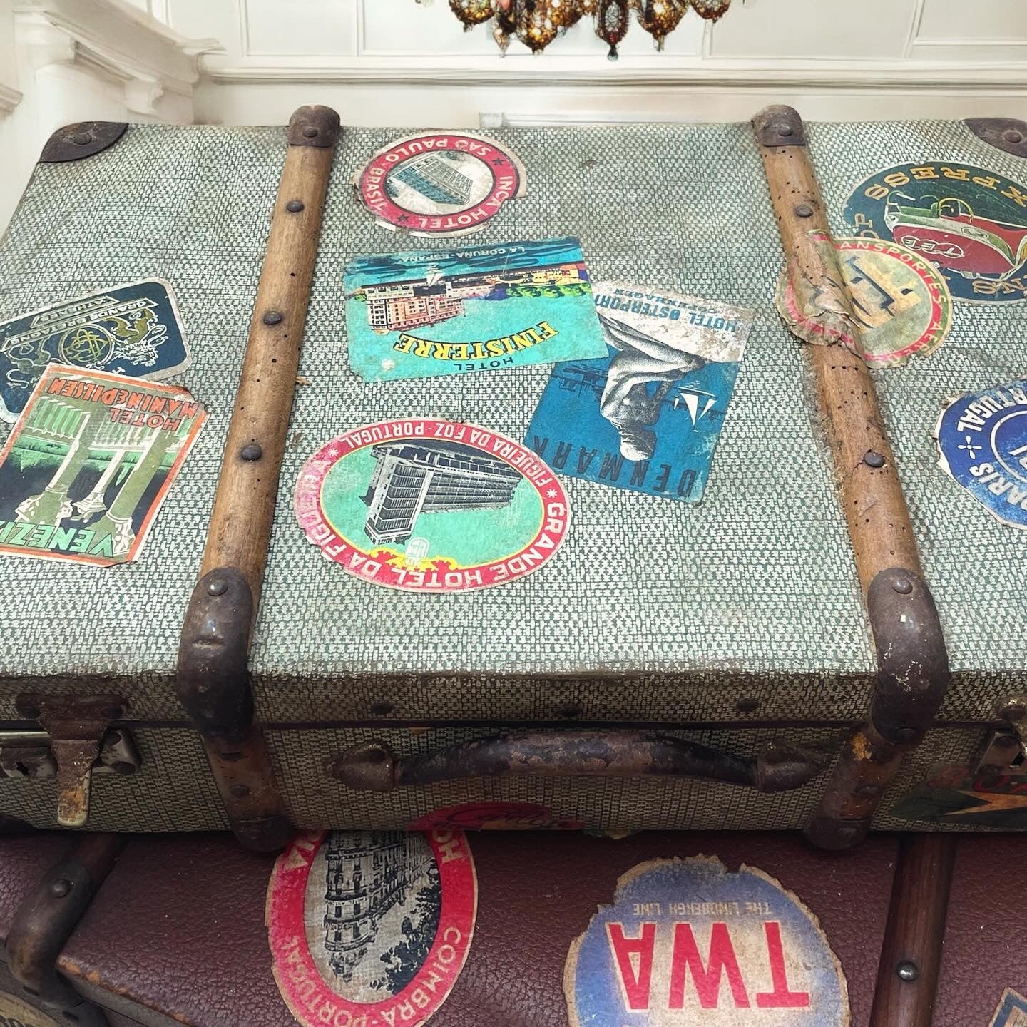 Set of three antique suitcases from 1900 with vintage stickers