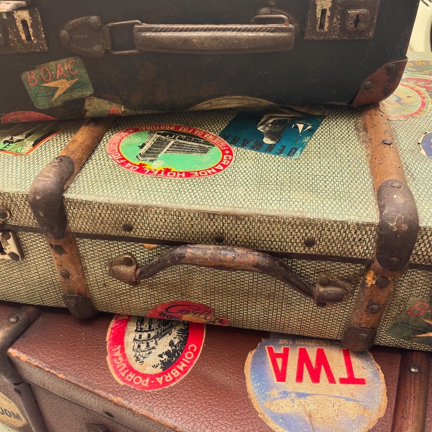 Set of three antique suitcases from 1900 with vintage stickers