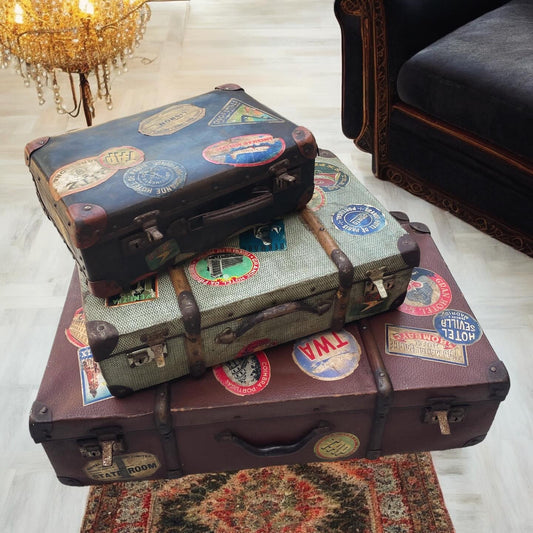 Set of three antique suitcases from 1900 with vintage stickers