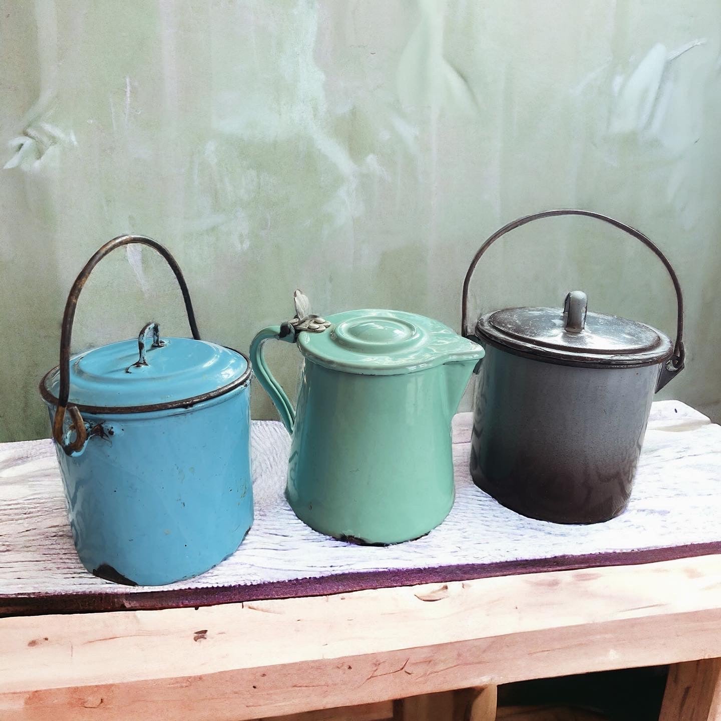 Set of three enameled saucepans and jug