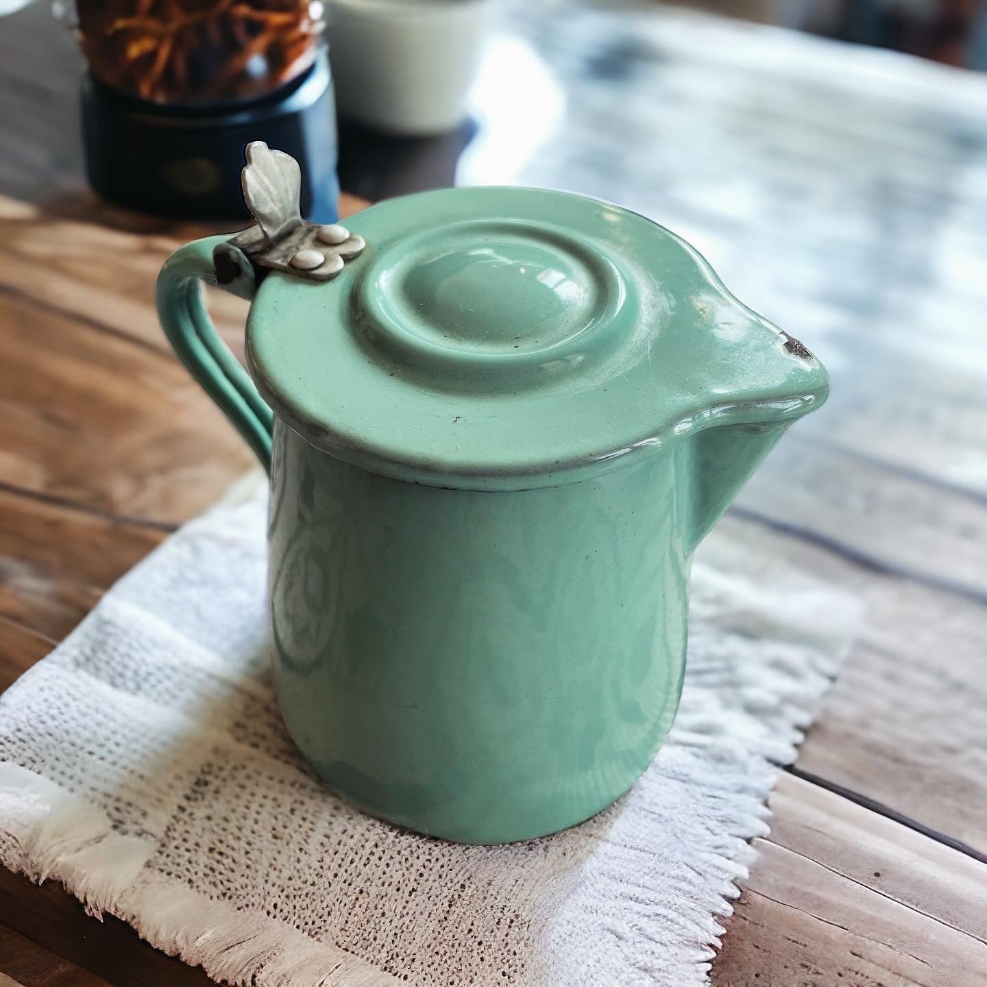 Set of three enameled saucepans and jug