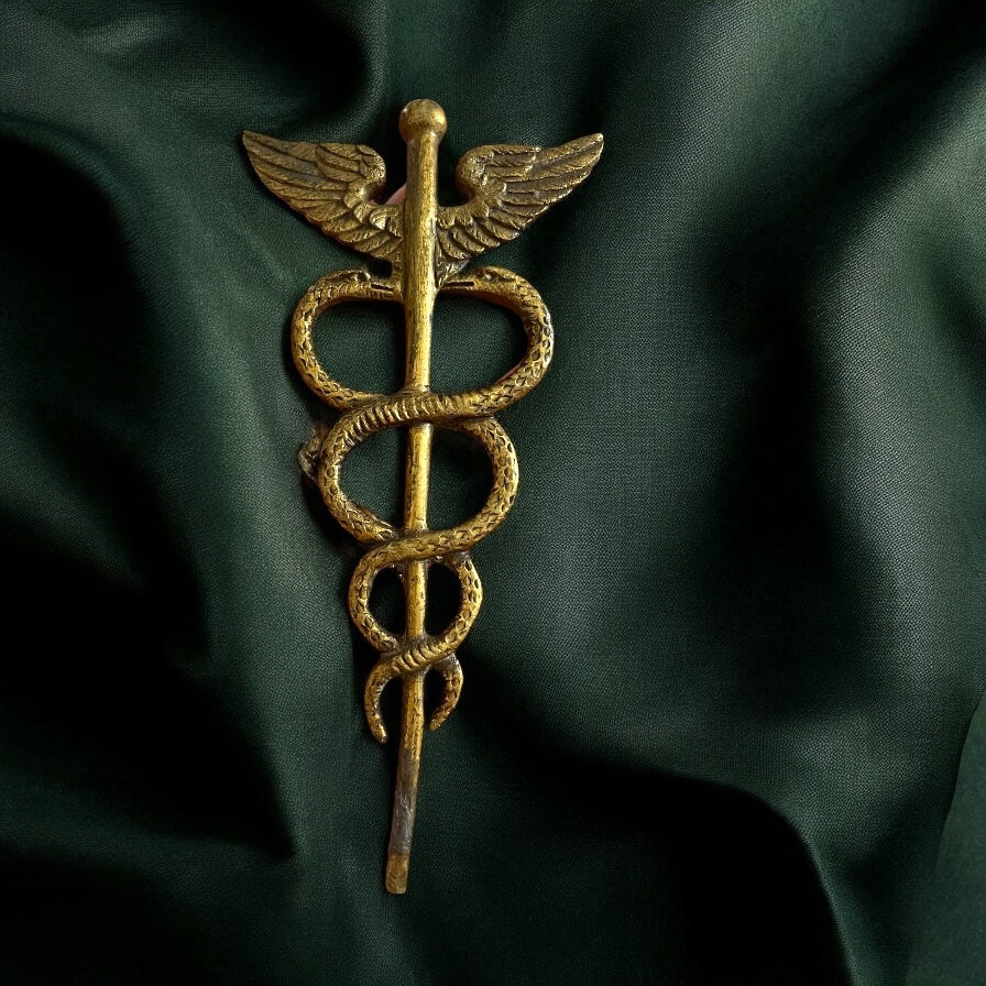 Antico fregio in ottone caduceo