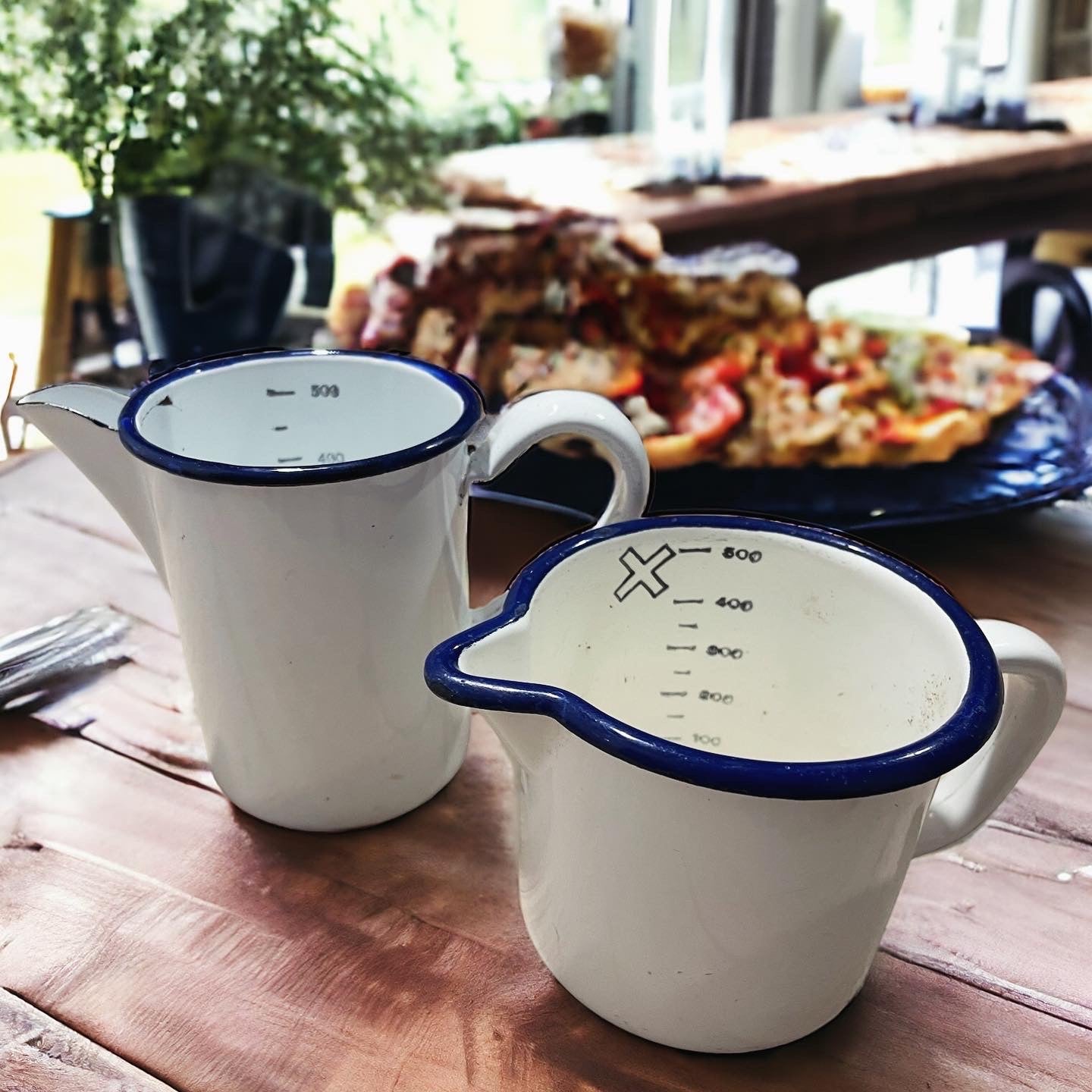 Pair of antique graduated enamel jugs