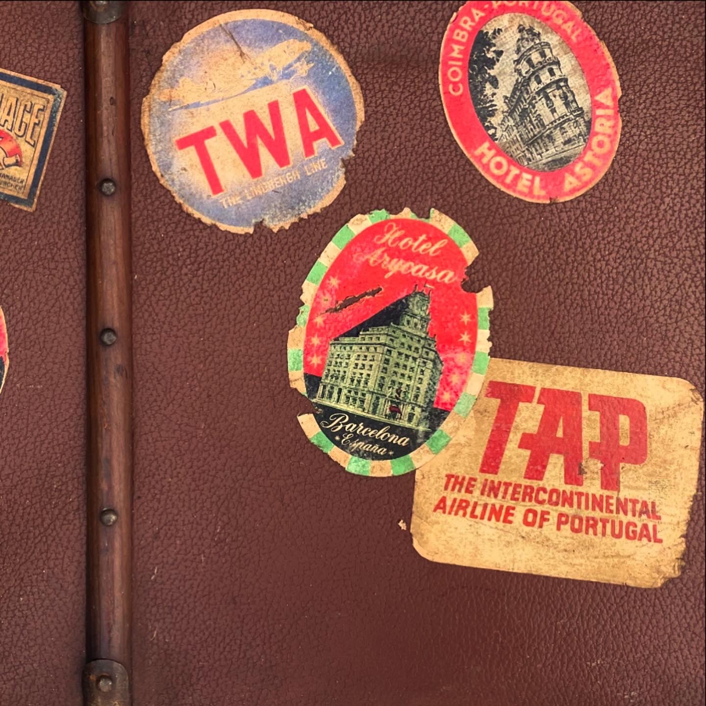 Set of three antique suitcases from 1900 with vintage stickers