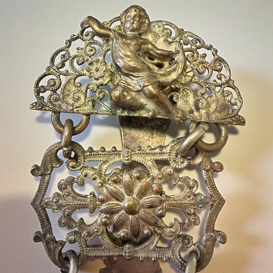 Chatelaine reggi calze con putti, lega metallica, fine ‘800 - primo ‘900