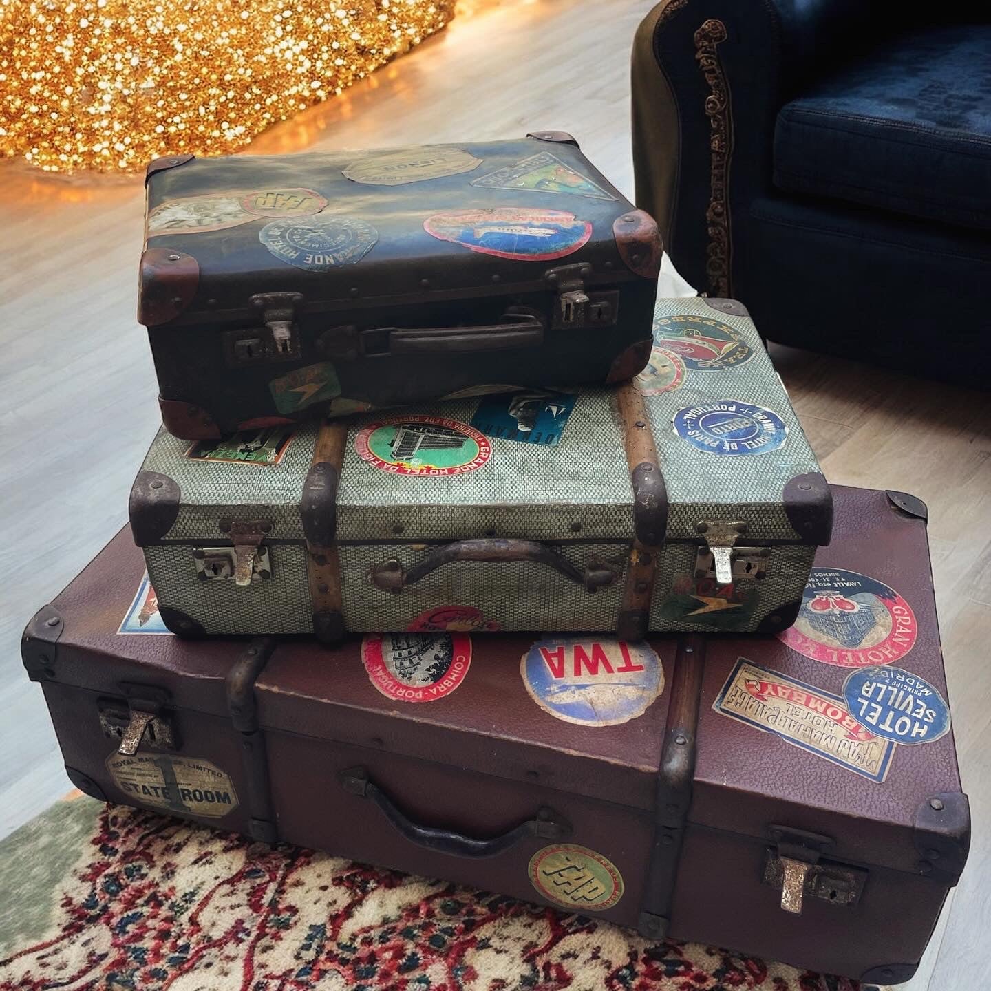 Set of three antique suitcases from 1900 with vintage stickers