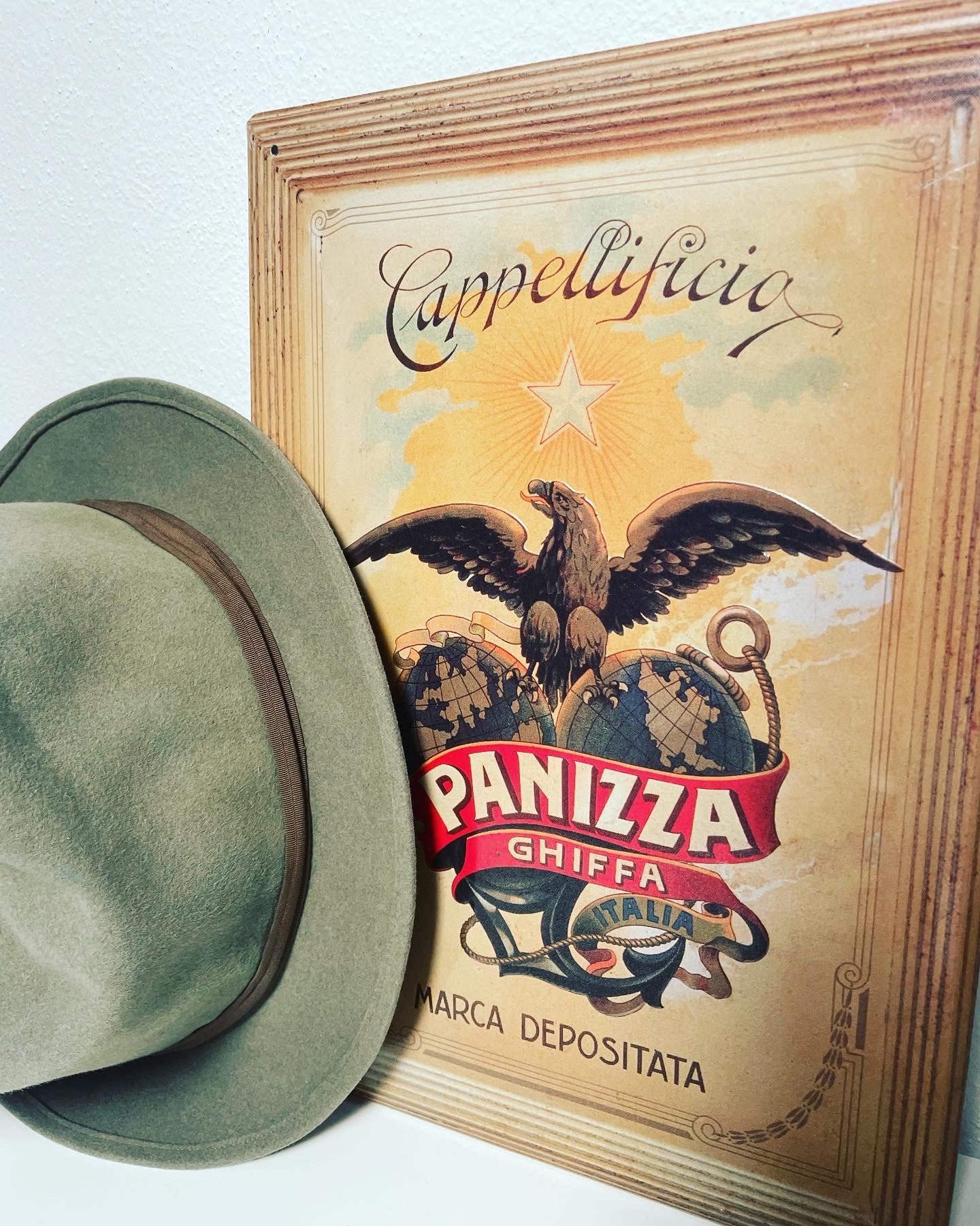 Panizza hat and sign