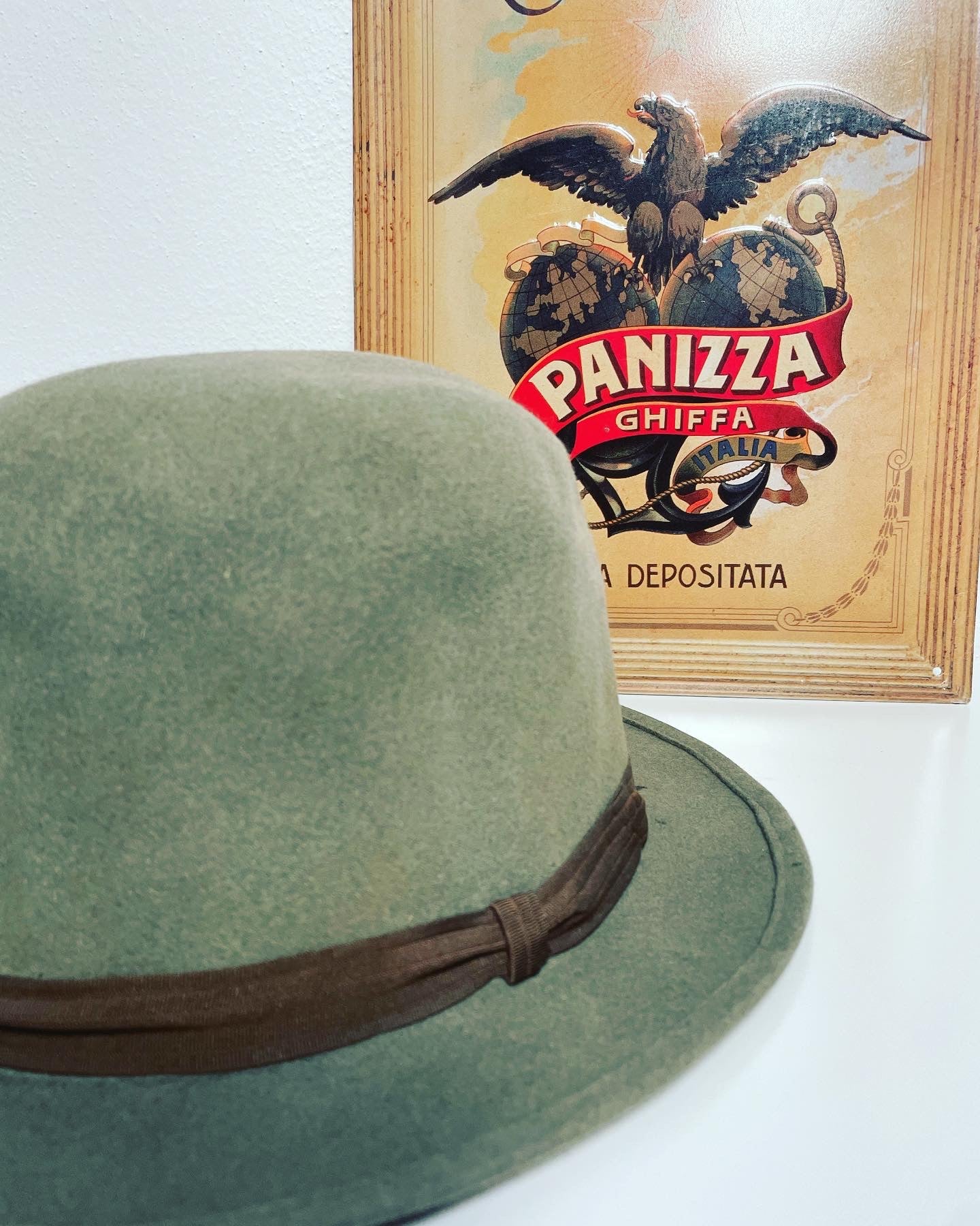 Panizza hat and sign