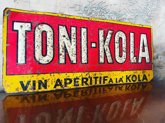 Insegna Toni Kola